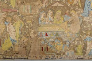 Détail du parement d’autel des Cordeliers de Toulouse, textile brodé du début du XIVᵉ siècle représentant plusieurs scènes religieuses avec personnages auréolés, motifs géométriques et architecture gothique.